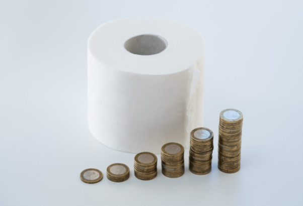 Toilet paper with stacks of coins